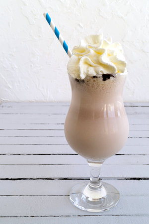 Chocolate cold cocktail on wooden grey table.