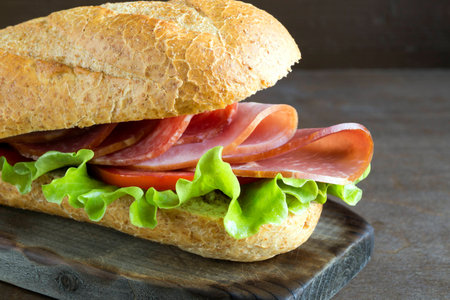 Sandwich with salami, ham and salad.の写真素材