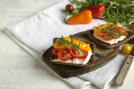 vegetarian food. rye bread with soft cheese and vegetables.