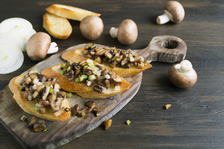 Fried baguette slices with mushrooms, garlic and herbs.の写真素材