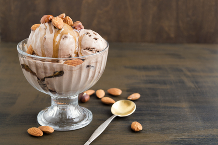 chocolate ice cream in a glass vase. on a wooden background.の写真素材