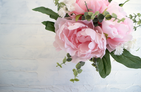 Pink artificial peonies on a light background.
の写真素材