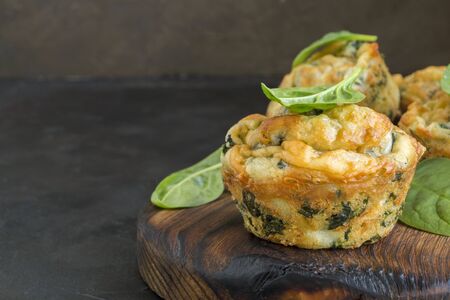 homemade cheese muffins with spinach. on dark background.の写真素材