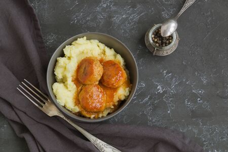 Meatballs in sweet and sour tomato sauce with mashed potatoes.