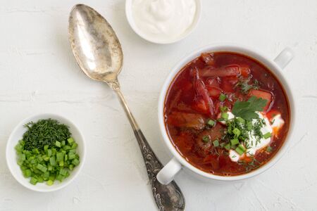 traditional Ukrainian Russian soup (borscht) from beet with greens and sour cream.