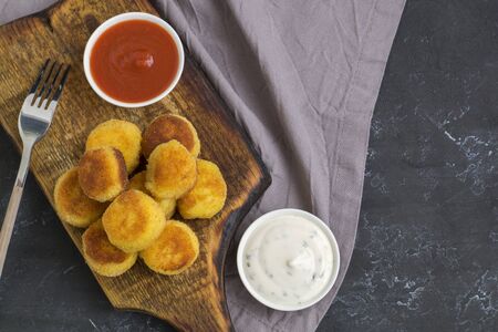 breaded fried potato balls with tomato sauce