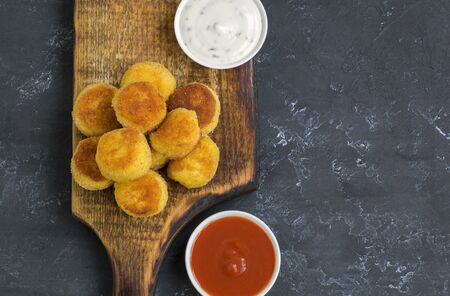 breaded fried potato balls with tomato sauceの写真素材