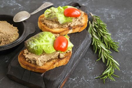 homemade meat pate on toasted crusty bread. dark photo style.の写真素材