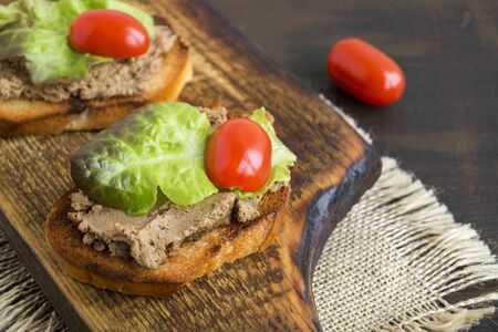 homemade meat pate on toasted crusty bread. dark photo style.の写真素材