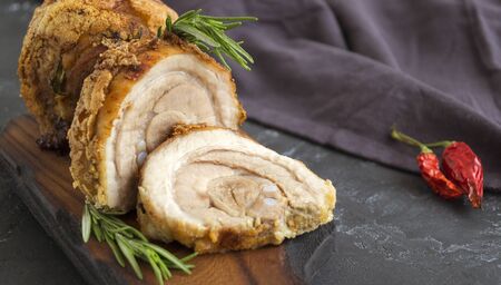 meat delicacy. pork roll with spices on a dark background.の写真素材