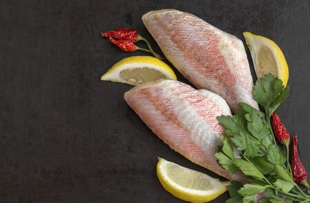 red sea bass fish on black background.