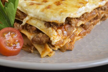 Meat lasagna on a wooden background.
の写真素材