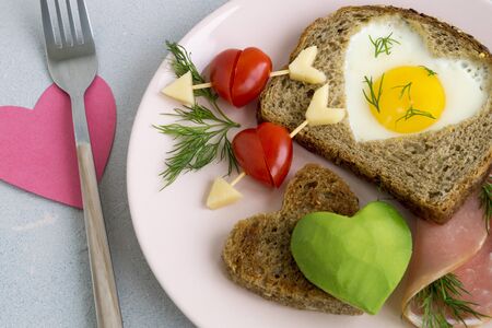 Breakfast for Valentine's day. egg and toast in the shape of a heart.