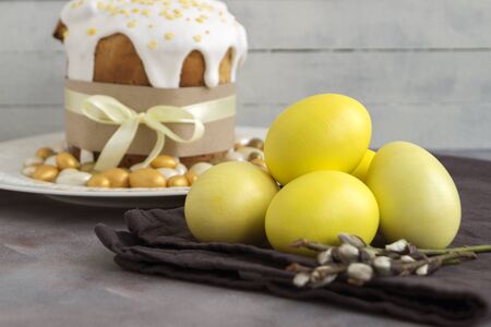Easter food. Easter cakes and painted eggs. in yellow tones.