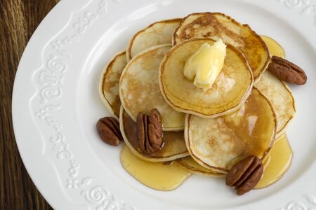 pancakes with butter and honey. Breakfast on a white plate.