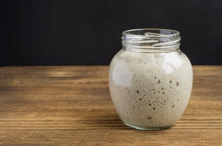 Active rye sourdough in a glass jar for homemade bread.の写真素材