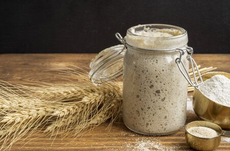 Active rye sourdough in a glass jar for homemade bread.の写真素材