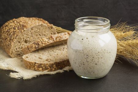 Active rye sourdough in a glass jar for homemade bread.