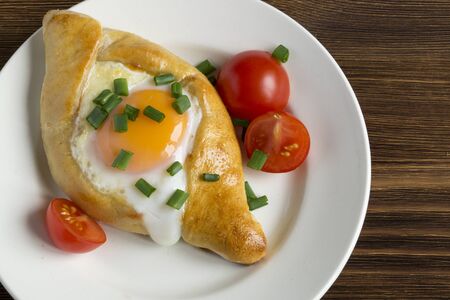 Ajarian khachapuri with egg. traditional Caucasian dish.の写真素材