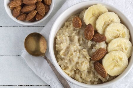 useful oatmeal porridge with almonds and bananas.の写真素材