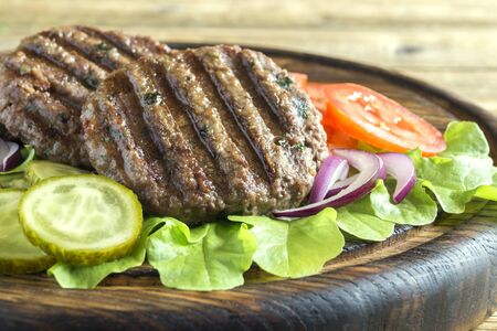 ingredients for a homemade Burger on a wooden Boardの写真素材