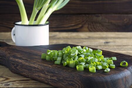 young green sliced onions. on a wooden Board