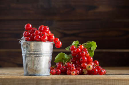 ripe red currants on a wooden backgroundの写真素材