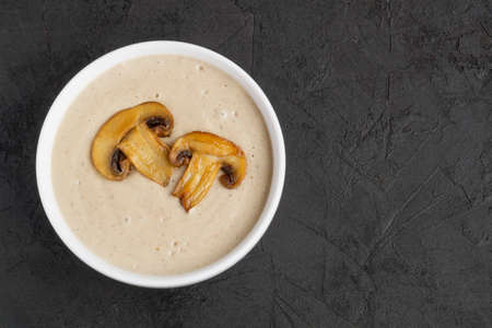 homemade cream sauce with mushrooms on a black background.の写真素材