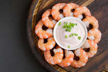 boiled prawns with sauce on a wooden Board.の写真素材
