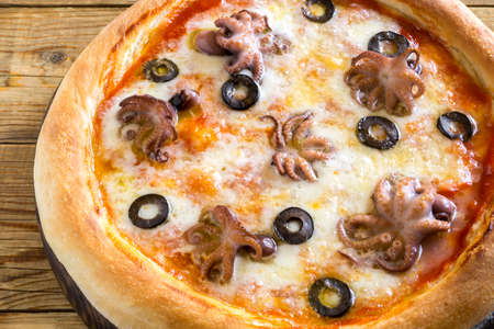 Traditional Italian dish, delicious pizza with seafoodの写真素材