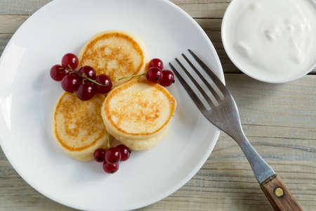 Cottage cheese pancakes, syrniki with fresh berries for breakfastの写真素材