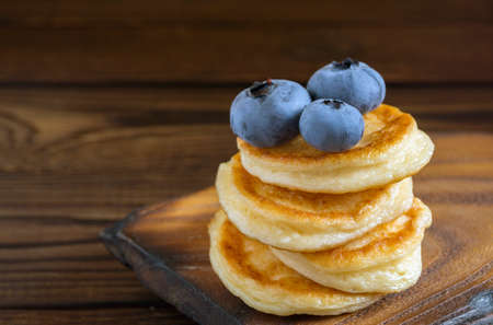 Cottage cheese pancakes, syrniki with fresh berries for breakfastの写真素材