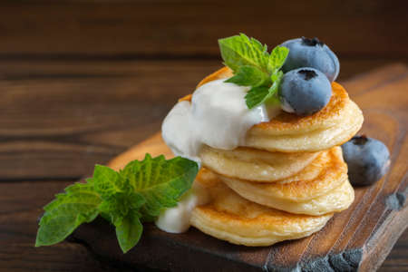 Cottage cheese pancakes, syrniki with fresh berries for breakfastの写真素材