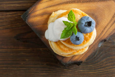 Cottage cheese pancakes, syrniki with fresh berries for breakfastの写真素材