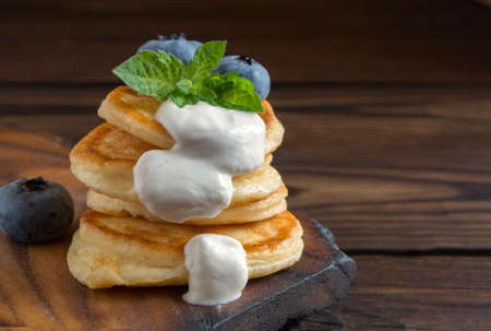 Cottage cheese pancakes, syrniki with fresh berries for breakfastの写真素材