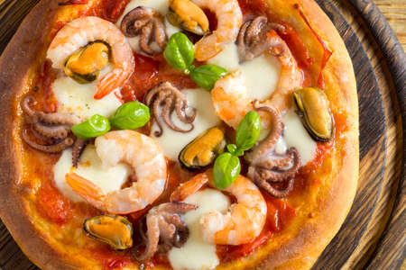 Traditional Italian dish, delicious pizza with seafoodの写真素材