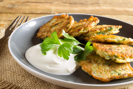 vegetarian healthy zucchini pancakes with herbs and sour creamの写真素材