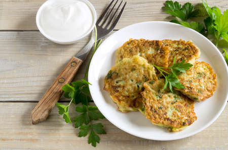 vegetarian healthy zucchini pancakes with herbs and sour creamの写真素材