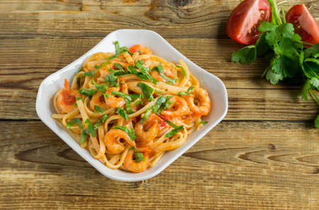 spaghetti with prawns in tomato sauce with herbs. traditional Italian cuisine.の写真素材