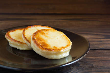 Cottage cheese pancakes on a black plateの写真素材