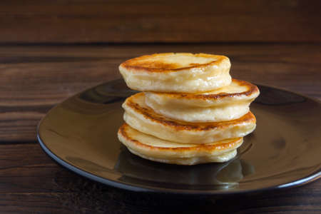 Cottage cheese pancakes on a black plate.の写真素材