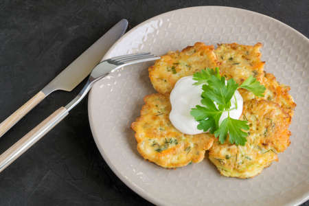 vegetarian healthy zucchini pancakes with herbs and sour creamの写真素材