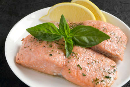 cooked salmon with spices. on a white plateの写真素材