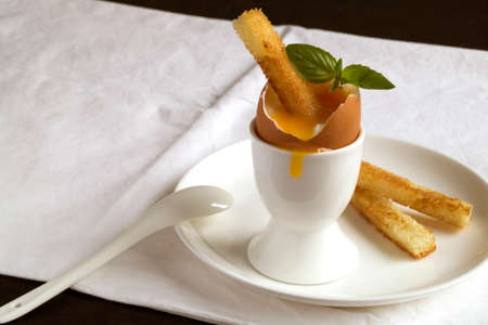 Soft-boiled egg for Breakfast. in a white egg rack.の写真素材