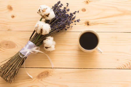 cup of coffee and lavender on a wooden trayの写真素材