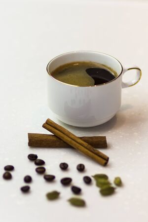 cup of coffee with cinnamon and cardamomの写真素材