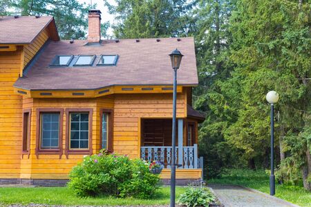 part of the modern house of laminated veneer lumber through the trees on a sunny dayのeditorial素材