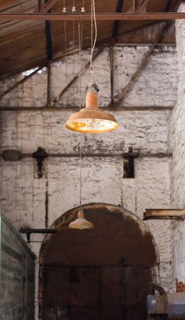 old rusty lamp hanging in an abandoned factoryの写真素材