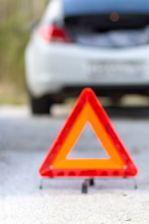 Blurred (out of focus) broken down car and emergency signの写真素材