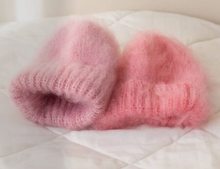 Two very fluffy pink hats in different shades associated manually